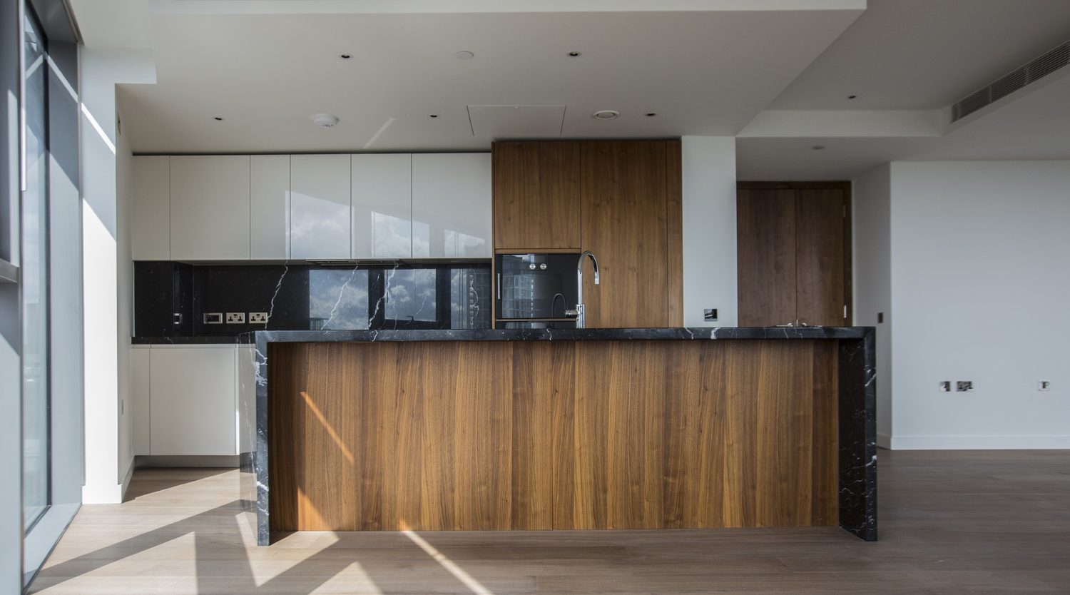 Kitchen with a timber island and black stone worktop