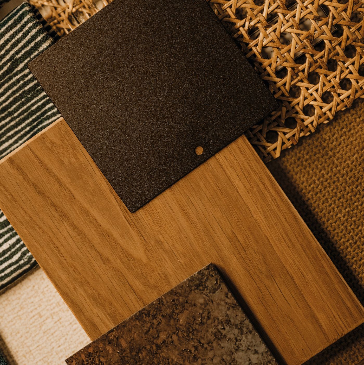 Samples of timber veneer, woven cane, leather and stone finishes