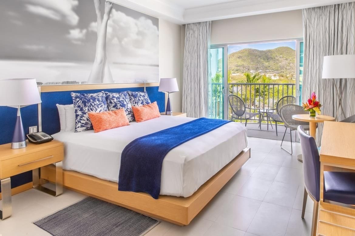 Guestroom with sea-blue accents and balcony