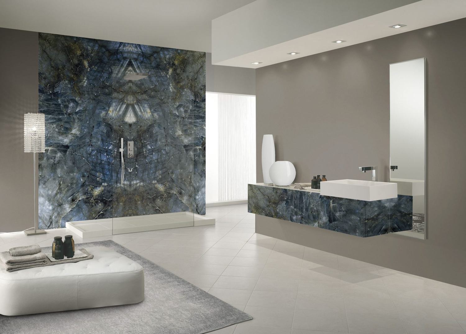 Blue-grey Emotion Wonder porcelain slab used as a shower wall and vanity front in a bathroom